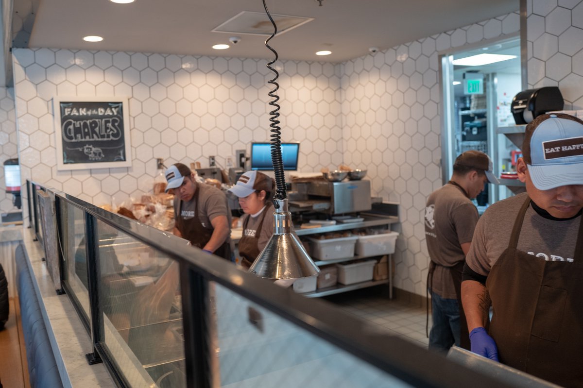 Restaurant staff members wearing nitrile protective gloves prepare meals at Mendocino Farms restaurant in Contra Costa County, San Ramon, California during an outbreak of the COVID-19 coronavirus, March 14, 2020. Restaurants were deemed essential services and allowed to operate take out services under a shelter in place order currently in effect in the region.