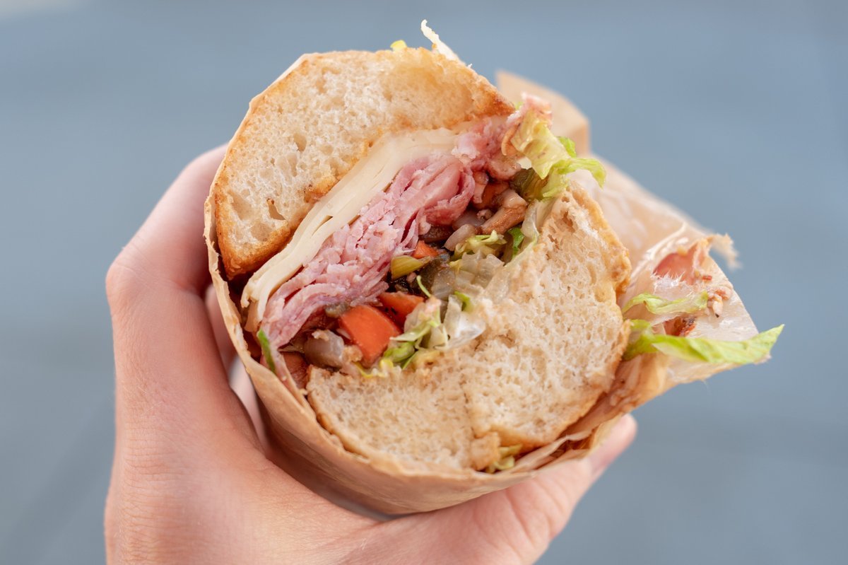 Close-up shot of a person holding a sandwich from Mendocino Farms, San Ramon, California, February 5, 2021.