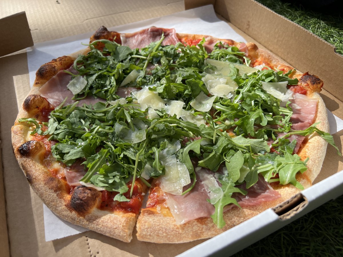 High-angle shot of Delarosa restaurants prosciutto, arugula, and shaved parmesan pizza, in an open cardboard takeaway box, near Bishop Ranch in San Ramon, California, November 6, 2022. Photo courtesy Sftm.