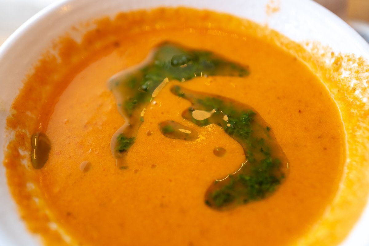 Close-up of tomato soup with swirl of basil pesto at Mendocino Farms restaurant, San Ramon, California, December 26, 2019.